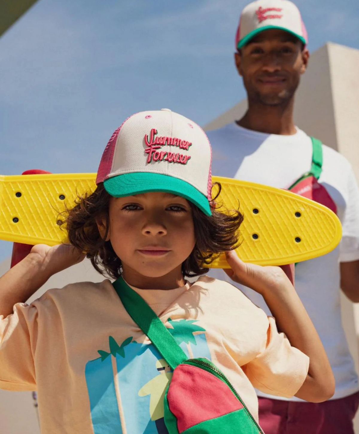 Father and son wearing matching Chamaye trucker caps