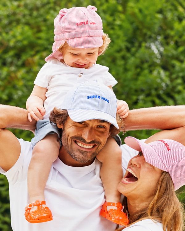 Dad, mum and child wearing matching Chamaye caps