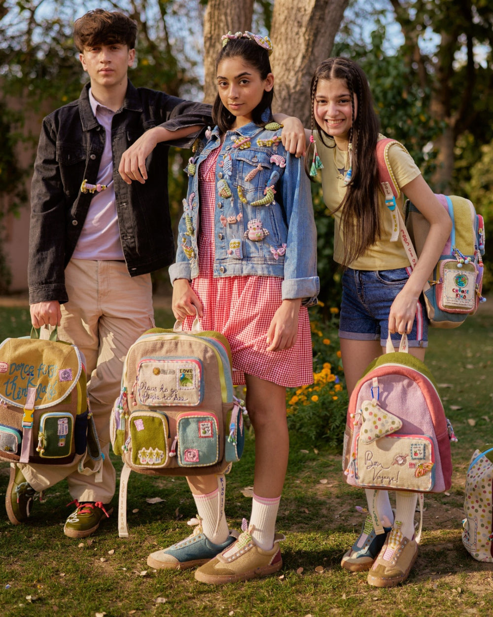 Kids in sneakers and backpacks standing outdoors