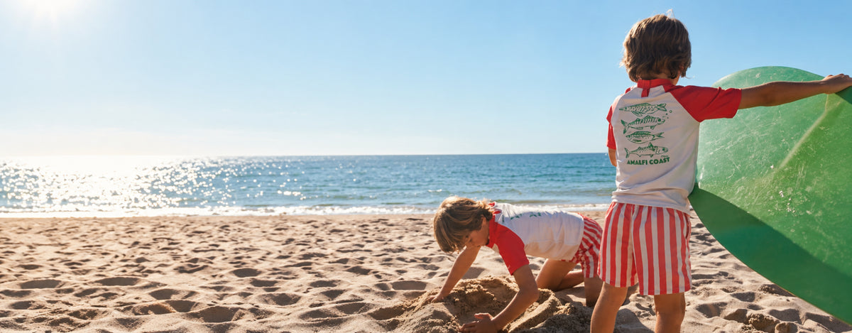 Kids in matching swimwear playing on the beach