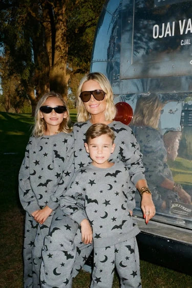 Mother and daughters in matching Beach Riot outfits
