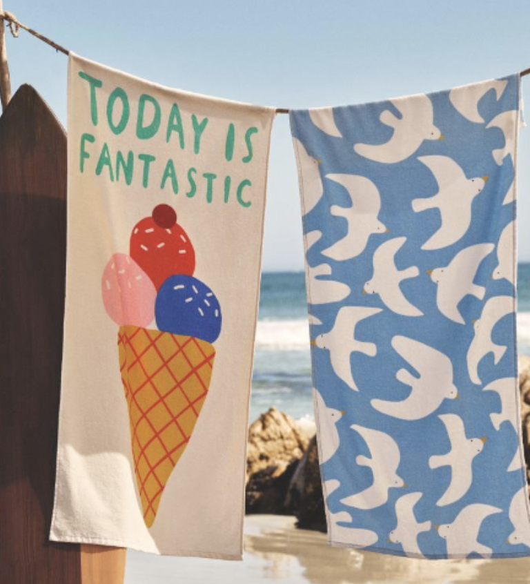 Colourful beach towels with ice cream and fish prints