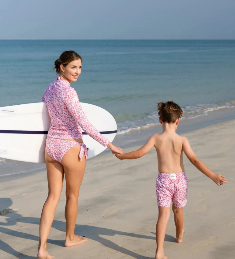 Mother and daughter in matching floral swimwear at the beach