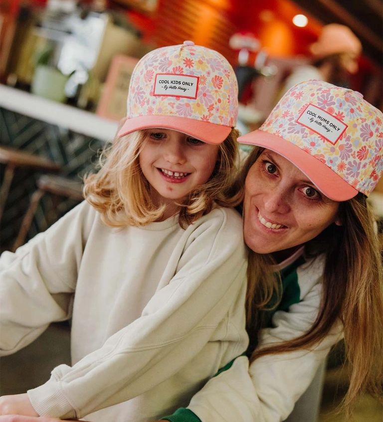 Mother and child in matching pink floral caps