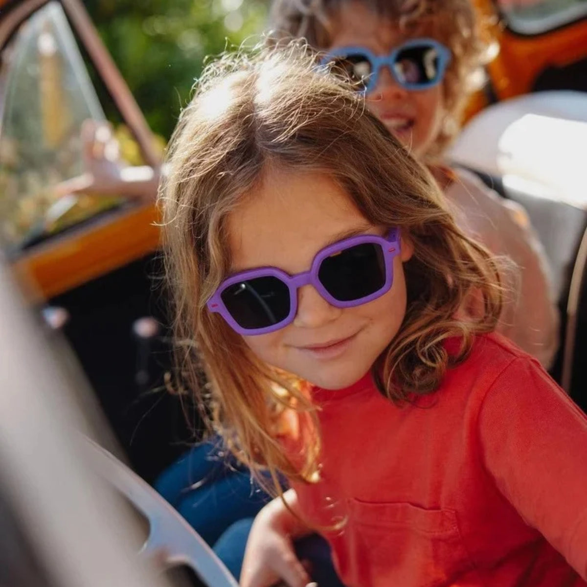 Girl wearing Hello Hossy kids' sunglasses