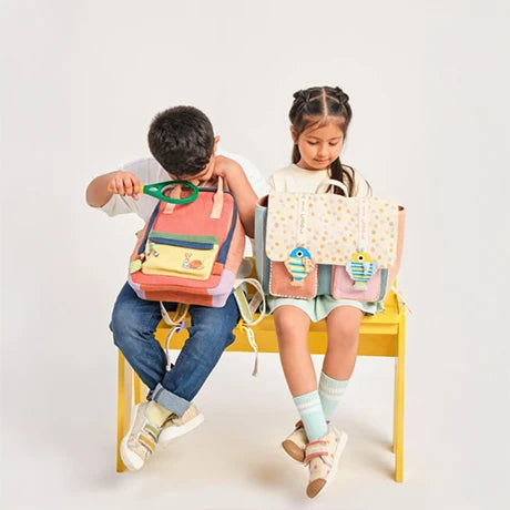 Kids with Choose Kind backpacks on a yellow bench